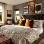 Modern bedroom with a dark tufted bed, rust-colored pillows, patterned bedding, and warm wood nightstands