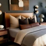 Small modern bedroom with a cognac upholstered bed, charcoal wall, abstract artwork, and wall sconces