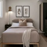 Small modern bedroom with soft taupe bedding, comfortable pillows, and a cream throw blanket
