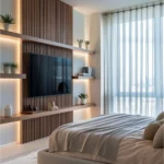 Warm modern bedroom with a wood-slat TV wall, built-in lighting, soft gray bedding, and a plush area rug