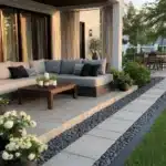 backyard covered patio with curtains and beautifully designed edge around patio