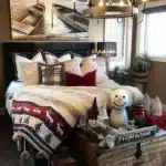 bedroom decorated for christmas nautical prints above bed christmas blanket on bed tray on bench at end of bed with snowman christmas trees christmas decor in bedroom