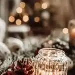 candle and pinecone on table decorated for christmas or winter
