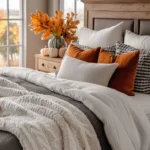 fall decorated bedroom with burnt orange throw pillows and pumpkin decor