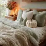 fall decorated bedroom with cream and mint green bedding wood accents pumpkin decor and candles fall bedroom
