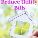 hand holding a house that says energy efficiency and says 75 easy ways to save energy at home and reduce utility bills