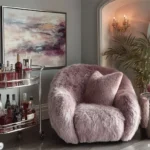 living room with cozy boucle chair metal drink cart and metal side table next to it