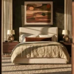 Neutral bedroom with a cream upholstered bed, dark accent wall, warm wood nightstands, abstract art, and a drum ceiling light.