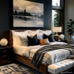 Neutral bedroom with oversized black-and-white landscape art, cream bedding, black pillows, a warm wood bed frame, and a charcoal throw.