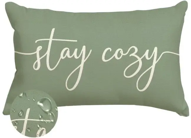 outdoor green lumbar pillow says stay cozy