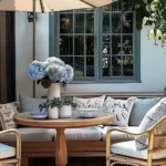 patio rule of 3 patio decor with an outdoor table with round bowls vase of flowers and small potted plants