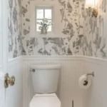 powder room with half wallpaper half wainscoting