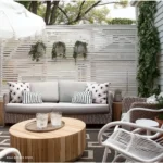 small backyard area with white painted chairs and refinished outdoor table